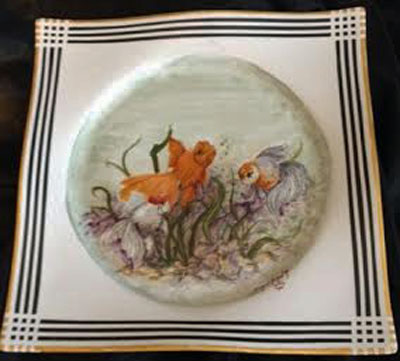 Painting of fish on a large porcelain plate by porcelain artist and china painting teacher, Pat McClendon.